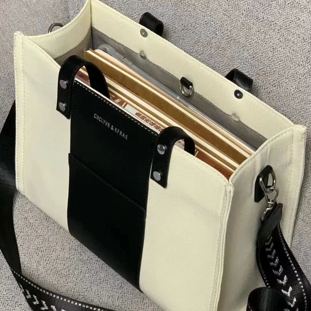 O1CN0131rgQt1GSSk3uCEhw_1717900621-1.webp 2022 New Simple Japanese Black and White Tote Bag Canvas Large Capacity Student Commuting Shoulder Messenger Bag - Image 1